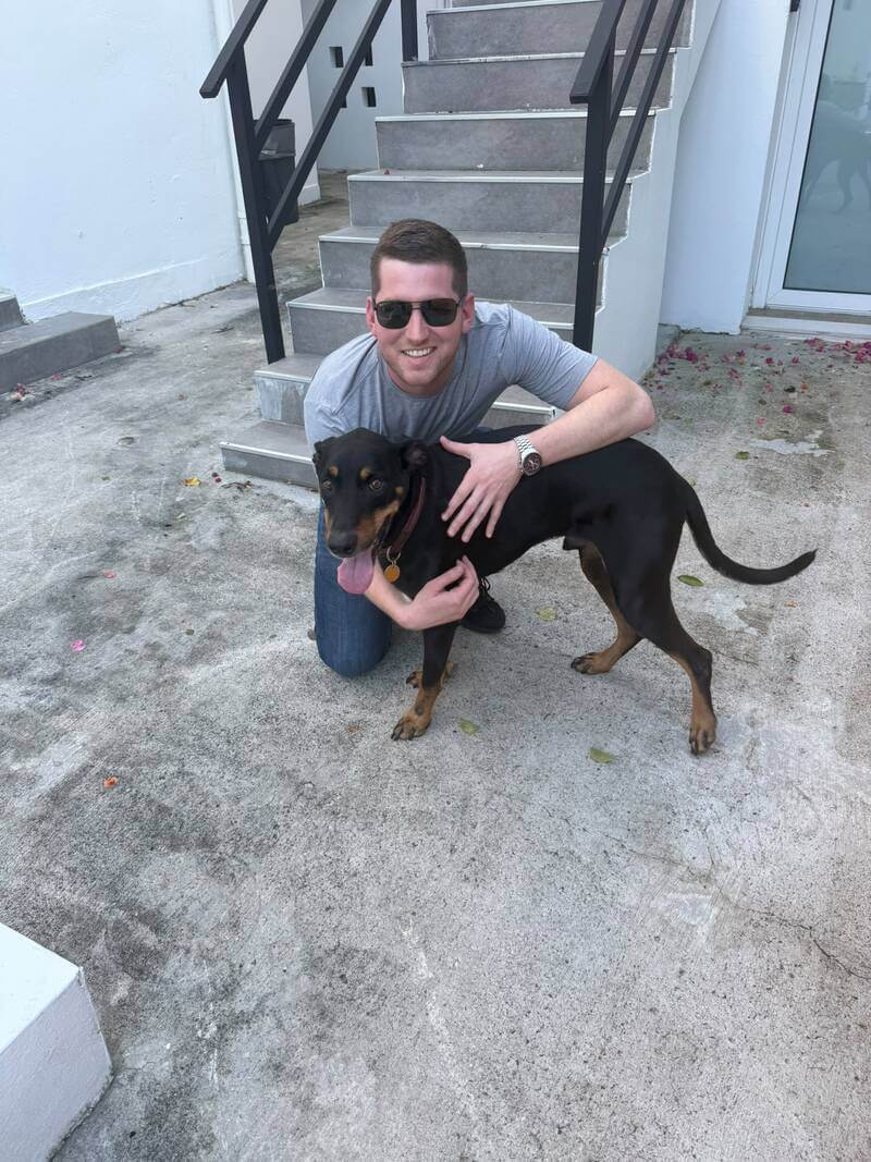 Kilo the dog reunited with his owner Sam on a patio stairwell in San Juan, Puerto Rico